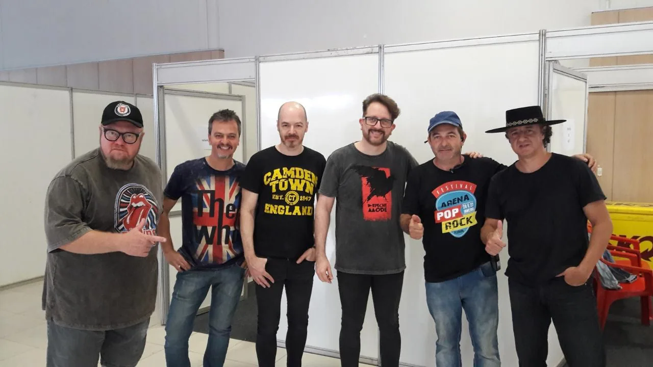 Banda e equipe reunidas nos bastidores